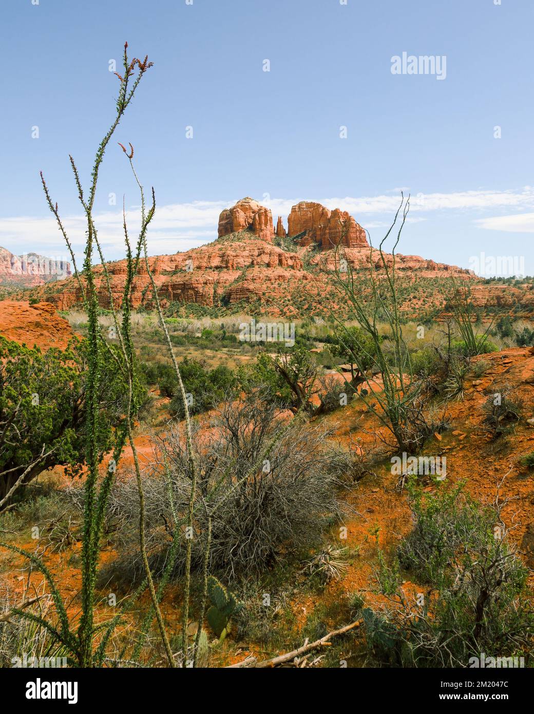 A view of Cathedral Rock in Sedona, AZ with two large rocks and a small spire in between, making the famous vortex site. Stock Photo