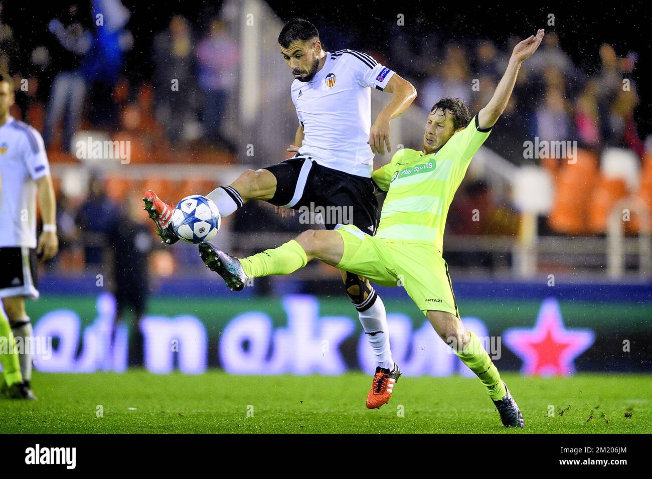 20151020 - VALENCIA, SPAIN: Valencia's Javi Fuego and Gent's Thomas Matton fight for the ball during a soccer game between Spanish club Valencia CF and Belgian team KAA Gent in Valencia, Spain, Tuesday 20 October 2015, game three in group H of the group stage of the UEFA Champions League tournament. BELGA PHOTO YORICK JANSENS Stock Photo