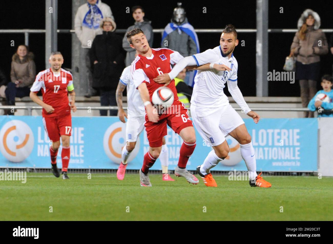 20151113 - DIFFERDANGE, LUXEMBOURG: Luxembourg's Chris Philipps and Greece's Panagiotis Tachtsidis fight for the ball during a friendly soccer game between Luxembourg national team and Greece, in Differdange, Luxembourg, Friday 13 November 2015. BELGA PHOTO SOPHIE KIP Stock Photo
