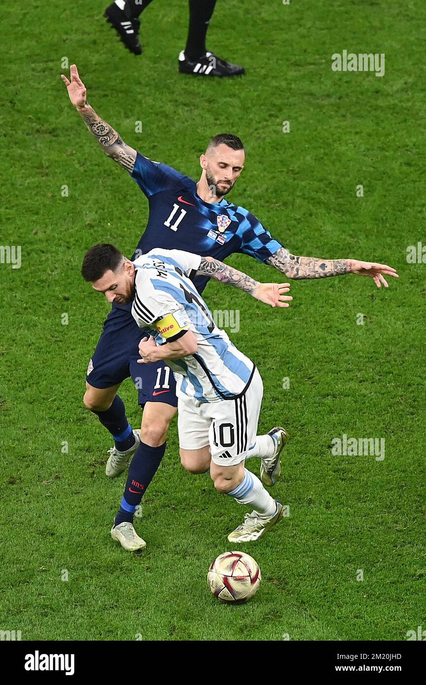 Lusail, Qatar. 13th Dec, 2022. Lionel Messi (front) of Argentina vies with Marcelo Brozovic of Croatia during the Semifinal between Argentina and Croatia at the 2022 FIFA World Cup at Lusail Stadium in Lusail, Qatar, Dec. 13, 2022. Credit: Li Jundong/Xinhua/Alamy Live News Stock Photo