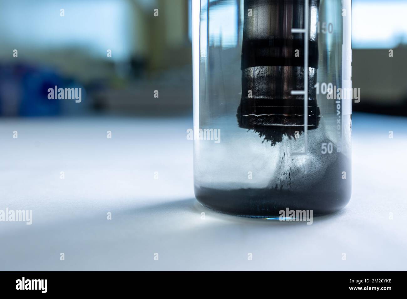 Iron nanoparticles in a lab, on a white glossy surface Stock Photo