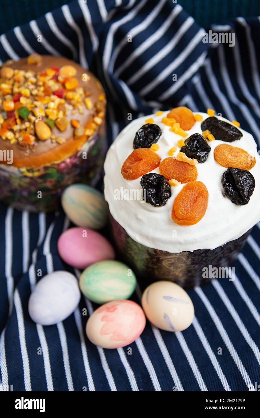 Easter eggs and Easter cakes lie on a striped blue apron. Easter religious holiday concept Stock Photo