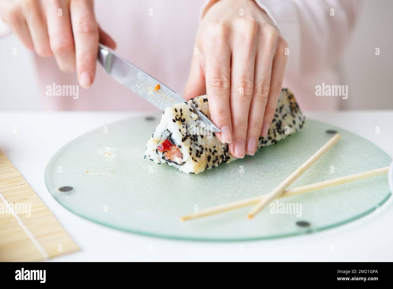 The process of making sushi, the girl makes sushi with different ...