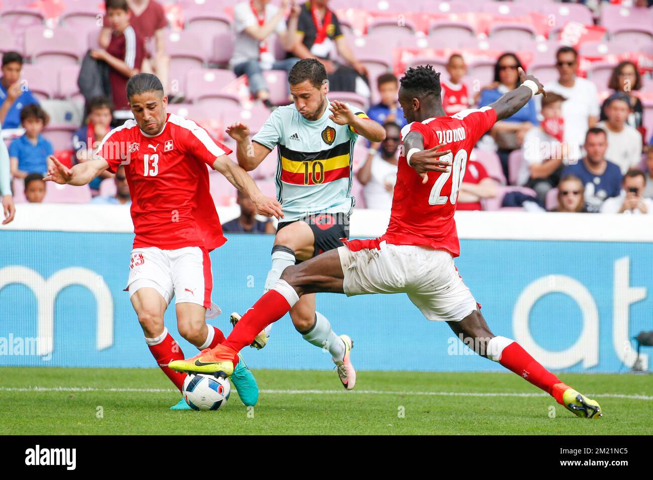 Switzerland's Ricardo Rodriguez, Belgium's Eden Hazard and Switzerland's Johan Djourou fight for the ball during a friendly soccer game between the Swiss national team and the Belgian national soccer team Red Devils, after a training camp, on Saturday 28 May 2016, in Geneve, Switzerland. The team is preparing for the upcoming Euro 2016 UEFA European Championship in France.  Stock Photo