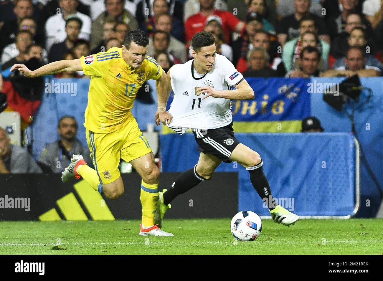 Ukraine's Artem Fedetskyi and Germany's Julian Draxler fight for the ball during a soccer game between Germany and Ukraine, in group C of the group stage of the UEFA Euro 2016 European Championships, Sunday 12 June 2016 in Lille, France. BELGA PHOTO LAURIE DIEFFEMBACQ Stock Photo