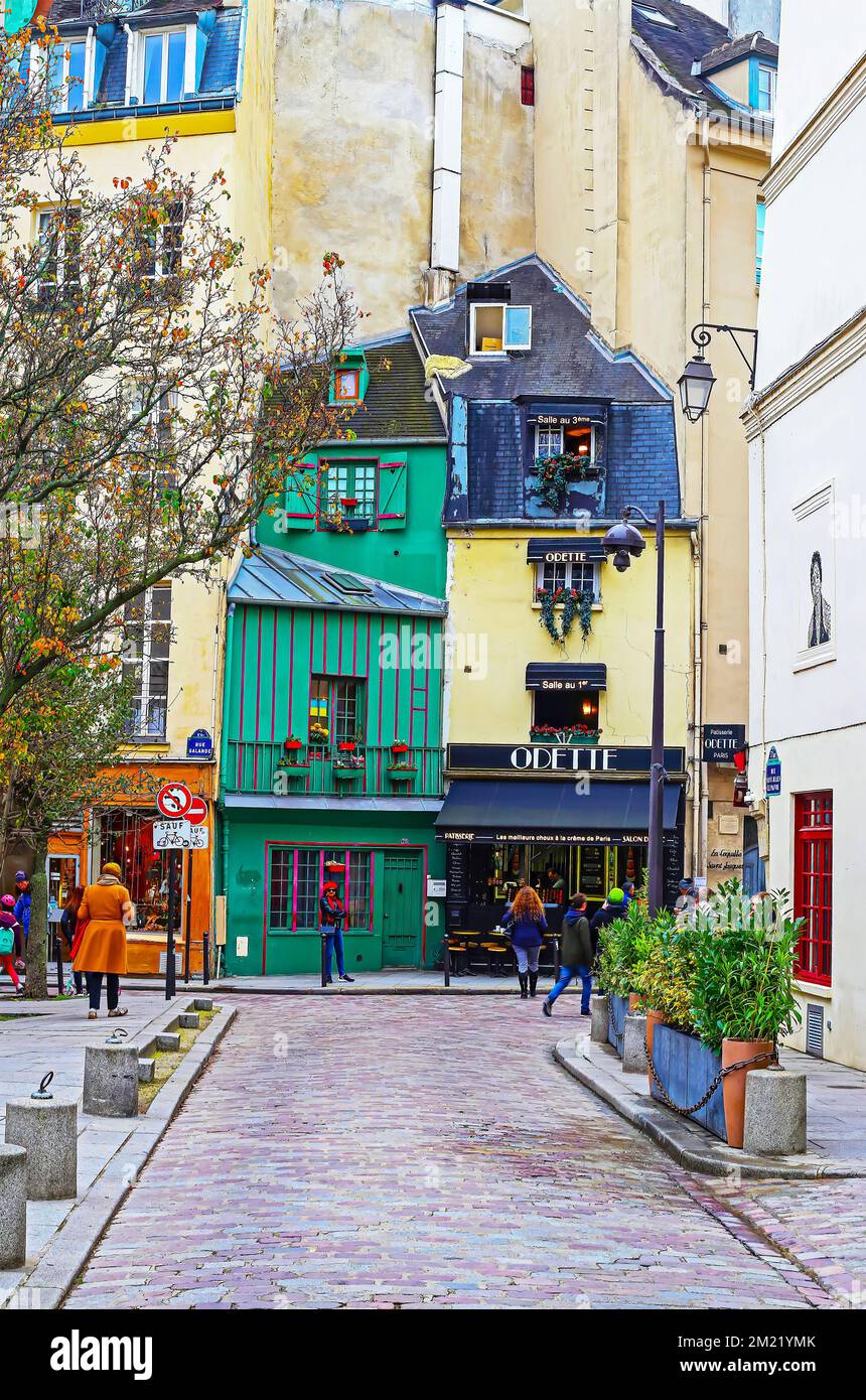Paris (Quartier Latin), France - November 9. 2022: Street view on ancient historical green, blue buildings with famous old vintage Odette patisserie Stock Photo