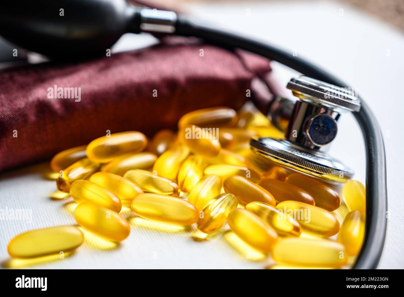 Omega 3 fish oil supplements with stethoscope and blood pressure cuff