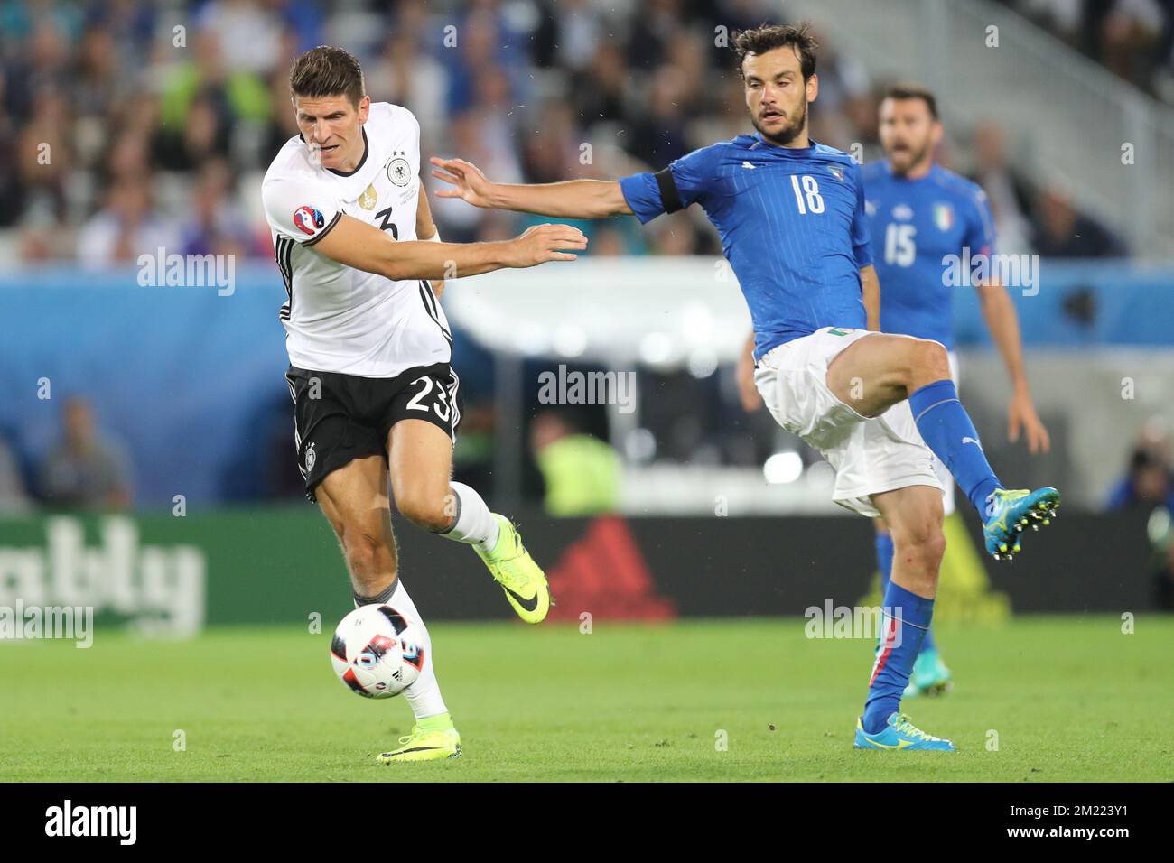 Germany's Mario Gomez and Italy's Marco Parolo fight for the ball during a soccer game between German team and Italian team, in the quarter-finals of the UEFA Euro 2016 European Championships, on Friday 01 July 2016, in Bordeaux, France.  Stock Photo