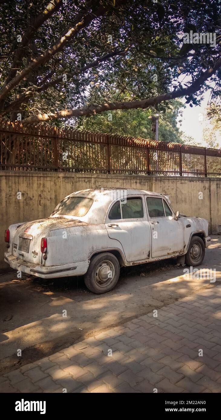 A vertical shot of a beige vintage car parked on a street Stock Photo ...