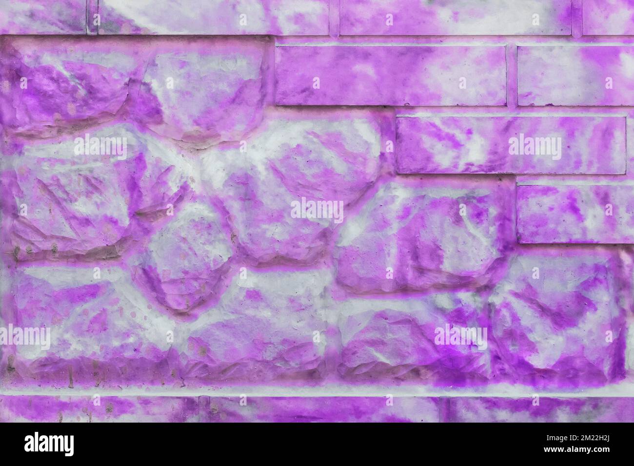 Decorative brick stone fence abstract purple pink spotted paint pattern modern interior wall texture background. Stock Photo