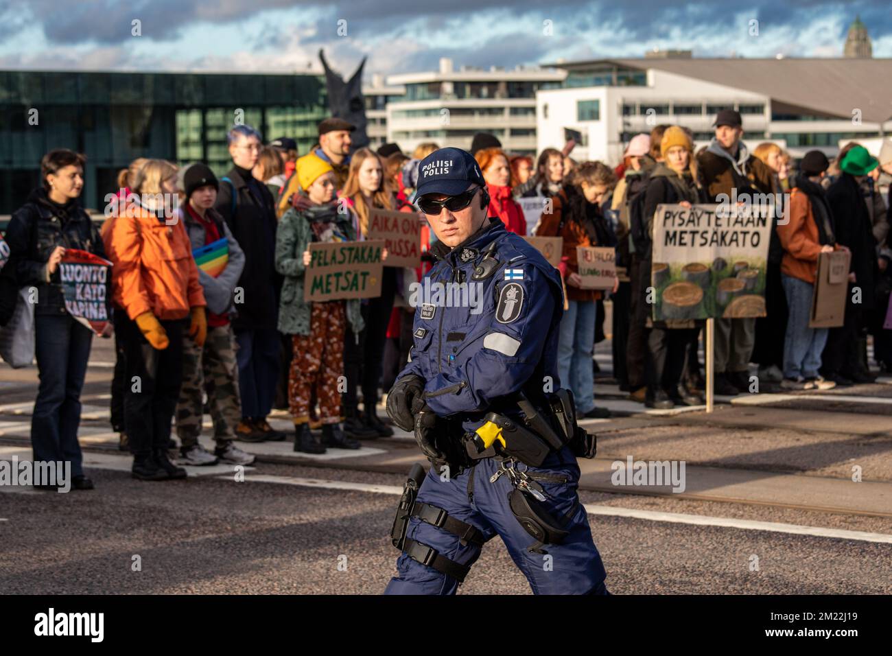 Police officer with sunglasses looking at camera at Elokapina or Extinction Rebellion road blocking protest on Mannerheimintie in Helsinki, Finland. Stock Photo