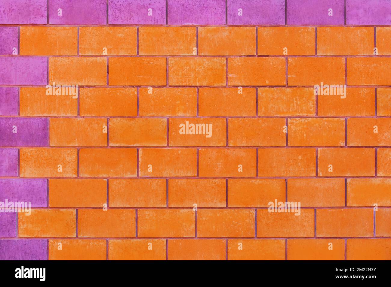 Orange and purple paint on brick blocks urban color vibrant design wall