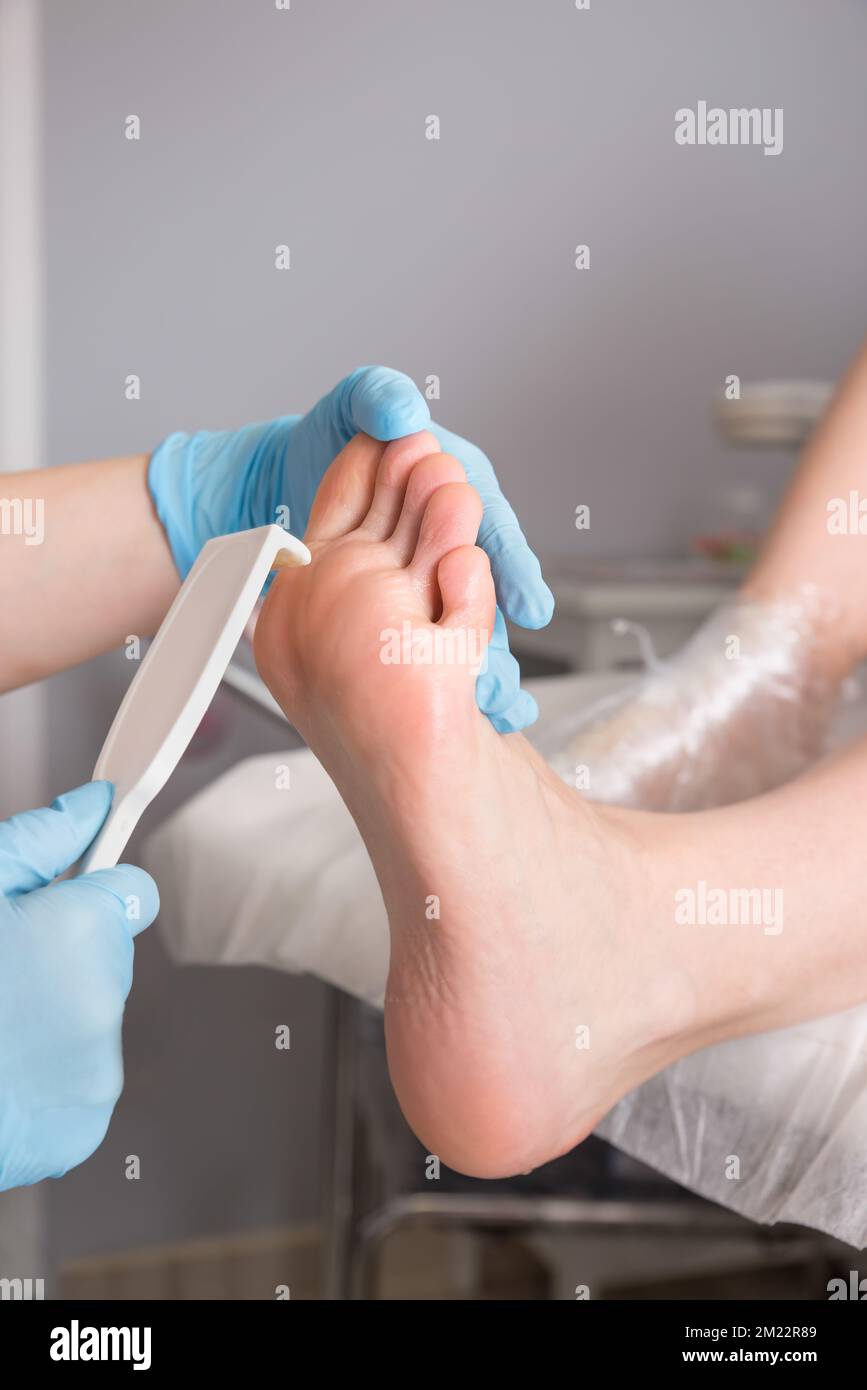 Peeling feet pedicure procedure. Pedicure SPA and foot care treatment