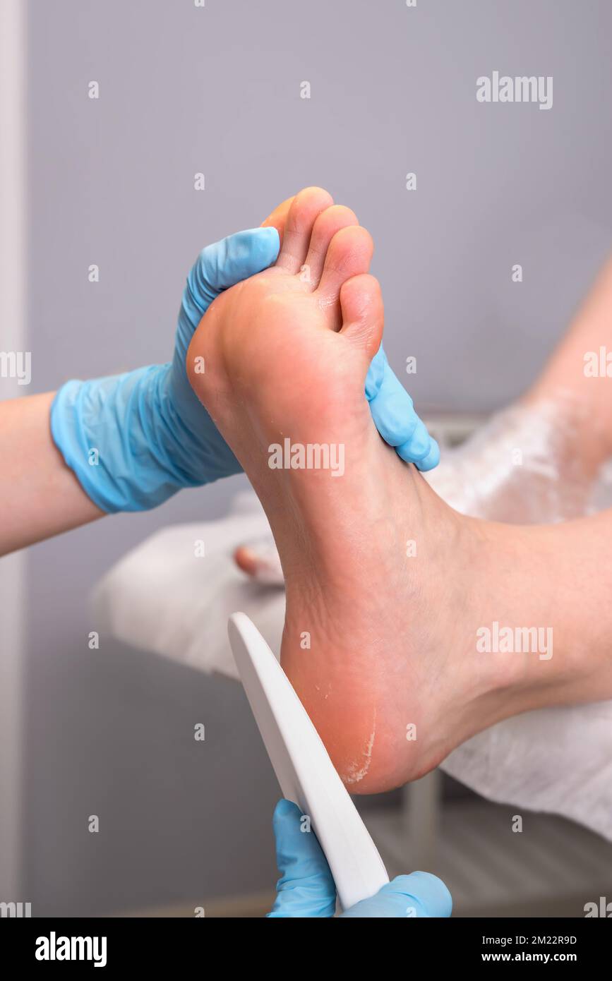 Peeling feet pedicure procedure. Pedicure SPA and foot care treatment