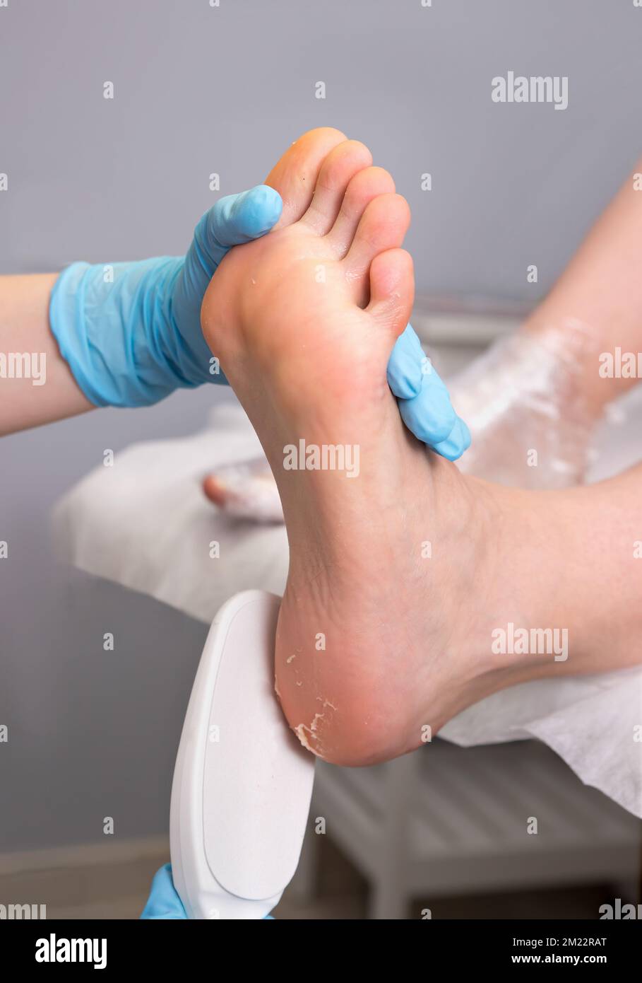 Peeling feet pedicure procedure. Pedicure SPA and foot care treatment and nail in the beauty salon. Scrub with pumice dead epidermis. Close up, select Stock Photo