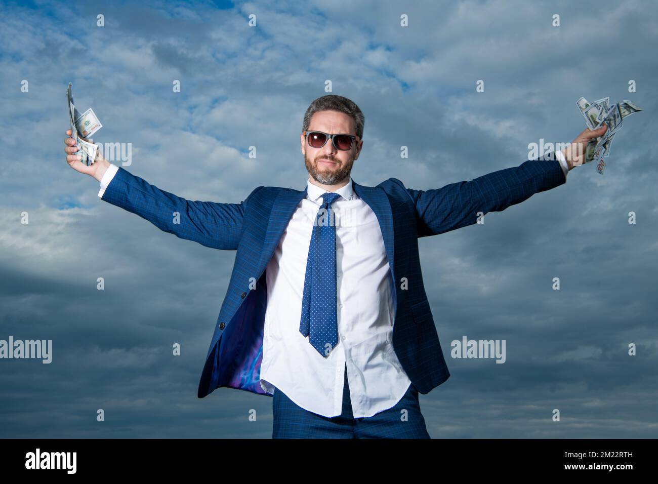 successful billionaire man with money on sky background. billionaire