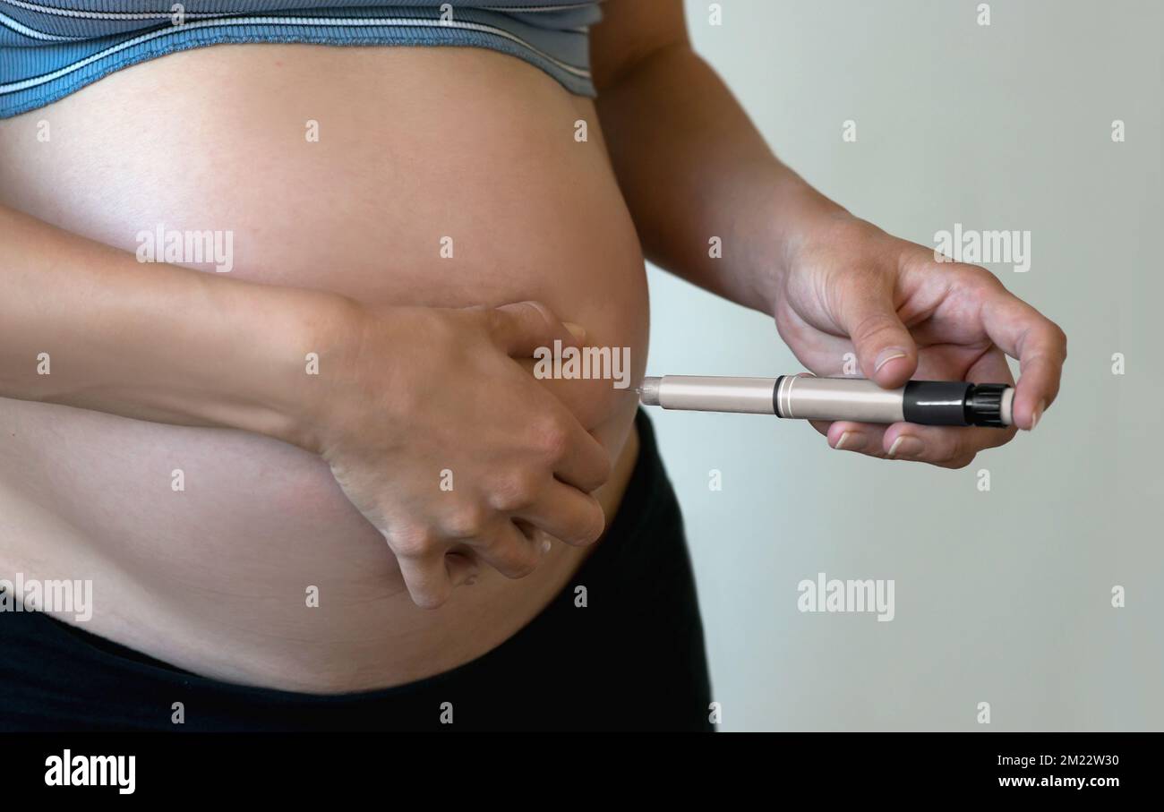 Injectable Pregnancy Pregnant woman makes injection of insulin in her belly. Diabetes and ...