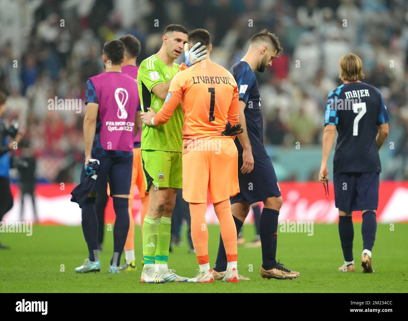 Argentina goalkeeper Emiliano Martinez consoles Croatia goalkeeper Dominik Livakovic after the FIFA World Cup Semi-Final match at the Lusail Stadium in Lusail, Qatar. Picture date: Tuesday December 13, 2022. Stock Photo