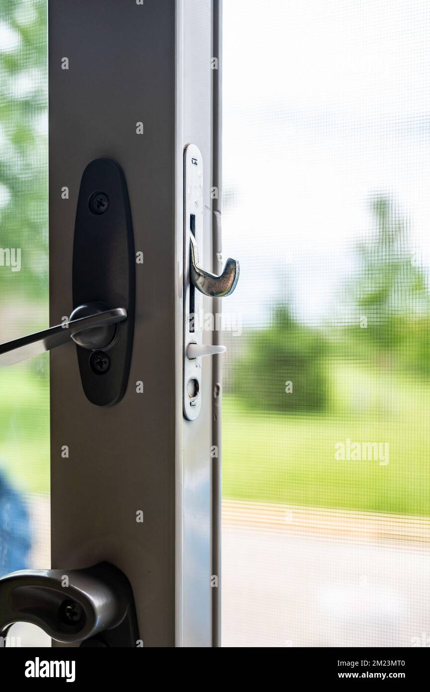 Handle, locking hardware, and jam to a sliding glass and screen door
