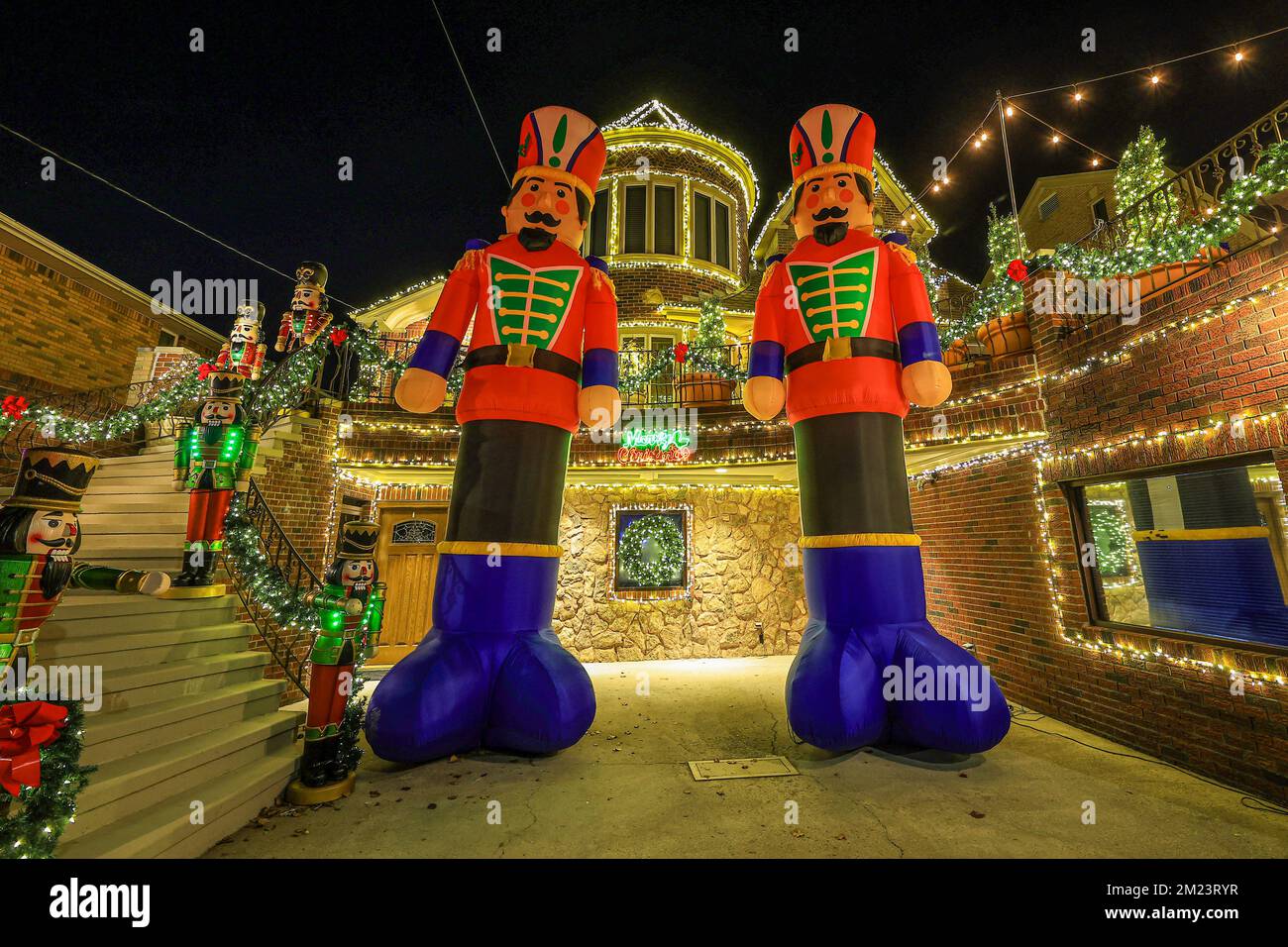 Thirty foot tall inflatable nutcracker figures stand in from of a home