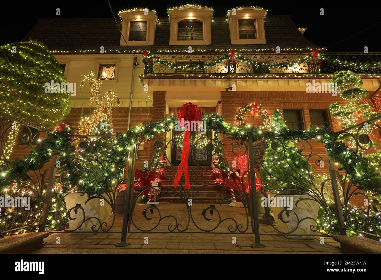 Wreaths and bows with lights enchant vistors to this home in the Dyker