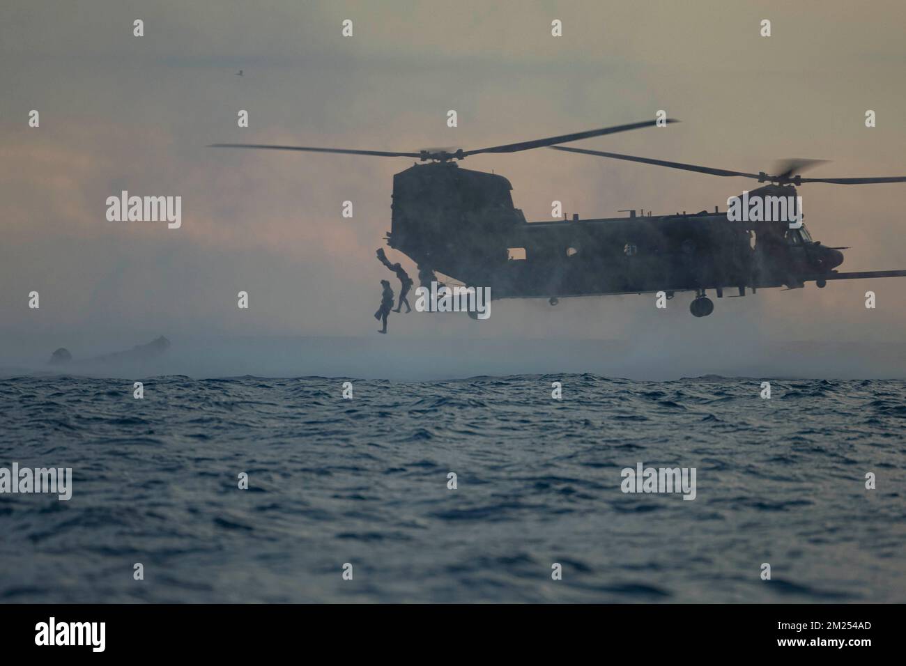 Camp Pendleton, California, USA. 2nd Dec, 2022. U.S. Marines with Bravo Company, 1st Reconnaissance Battalion, 1st Marine Division, jump from a U.S. Army MH-47 Chinook helicopter with 160th Special Operations Aviation Regiment during helocast training as part of Steel Knight 23 off the coast of Marine Corps Base Camp Pendleton, California, December. 2, 2022. Helocasting is a maritime insertion method for small units during amphibious operations. Steel Knight is an annual combined arms live-fire exercise which ensures 1st MARDIV is optimized for naval expeditionary warfare in contested spa Stock Photo