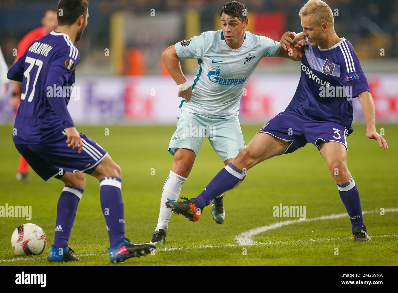 Zenit's midfielder's Giuliano and Anderlecht's Olivier Deschacht fight for the ball during a game between Belgian soccer team RSC Anderlecht and Russian team FC Zenit, first-leg of the 1/16 finals of the Europa League competition, Thursday 16 February 2017, in Brussels. BELGA PHOTO BRUNO FAHY Stock Photo