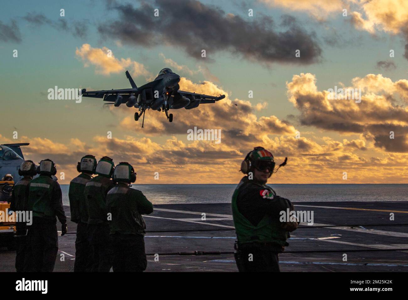 San Diego, United States. 07 December, 2022. U.S. Navy F/A-18F Super Hornet fighter aircraft, with the Black Aces of Strike Fighter Squadron 41 approaches for landing at sunset on the flight deck of the Nimitz-class aircraft carrier USS Abraham Lincoln, December 7, 2022 in San Diego, California.  Credit: MCS Julia Brockman/Planetpix/Alamy Live News Stock Photo