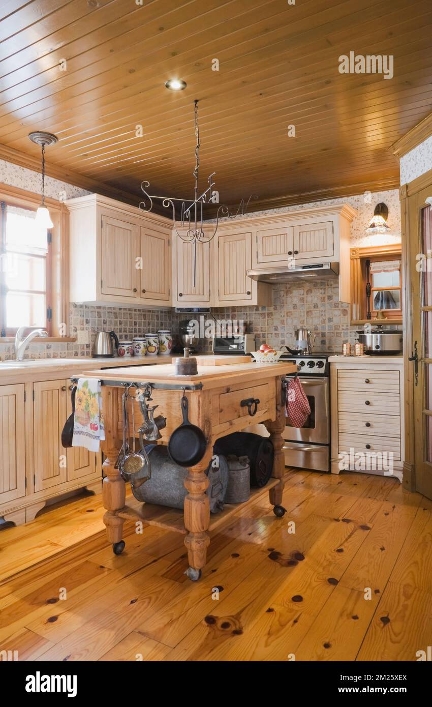 Antique wooden island in country style kitchen inside old Canadiana