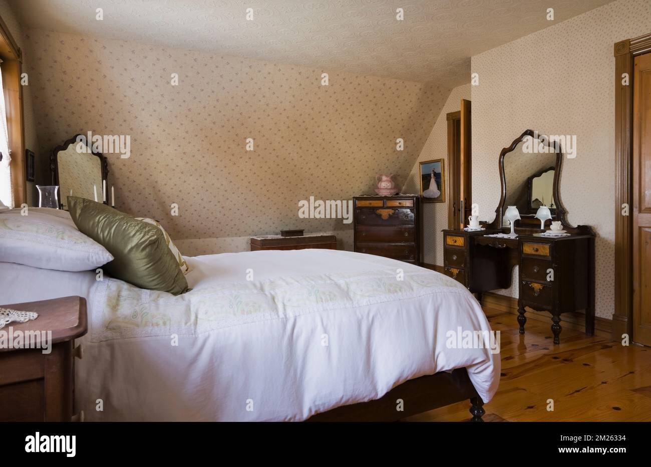 Double wood frame bed in master bedroom on upstairs floor inside old