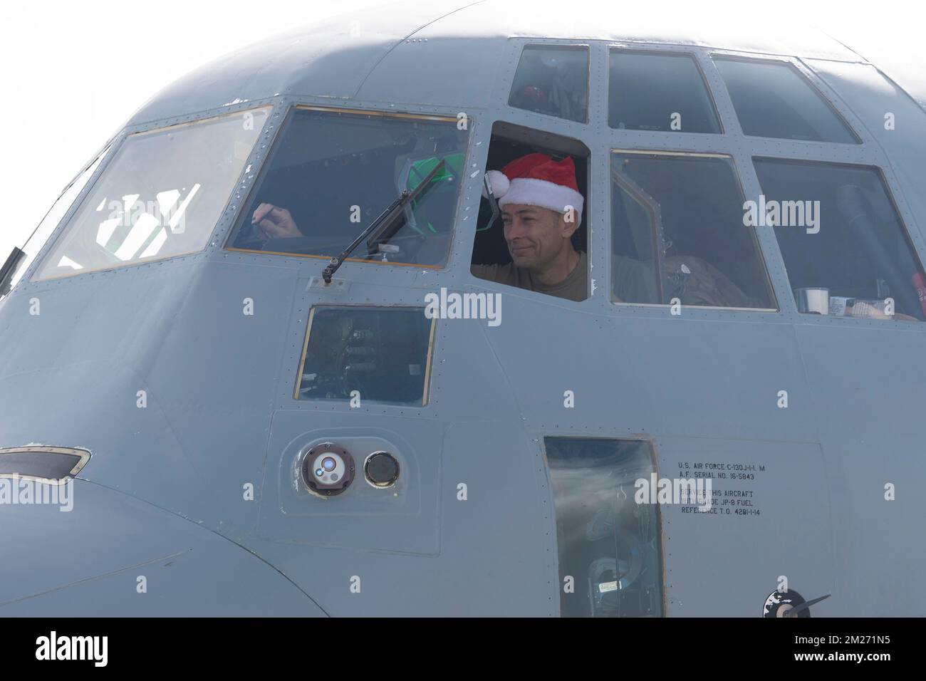 Yigo, United States. 03 December, 2022. U.S. Air Force Col. Andrew Roddan, 374th Airlift Wing commander, performs a pre-flight inspection wearing a Santa hat before taking off during Operation Christmas Drop 2022 at Andersen Air Force Base, December 3, 2022 in Yigo, Guam. Operation Christmas Drop is the oldest humanitarian and disaster relief mission delivering 71,000 pounds of food, gifts, and supplies to assist remote island communities in the South Pacific.  Credit: Yasuo Osakabe/US Airforce Photo/Alamy Live News Stock Photo