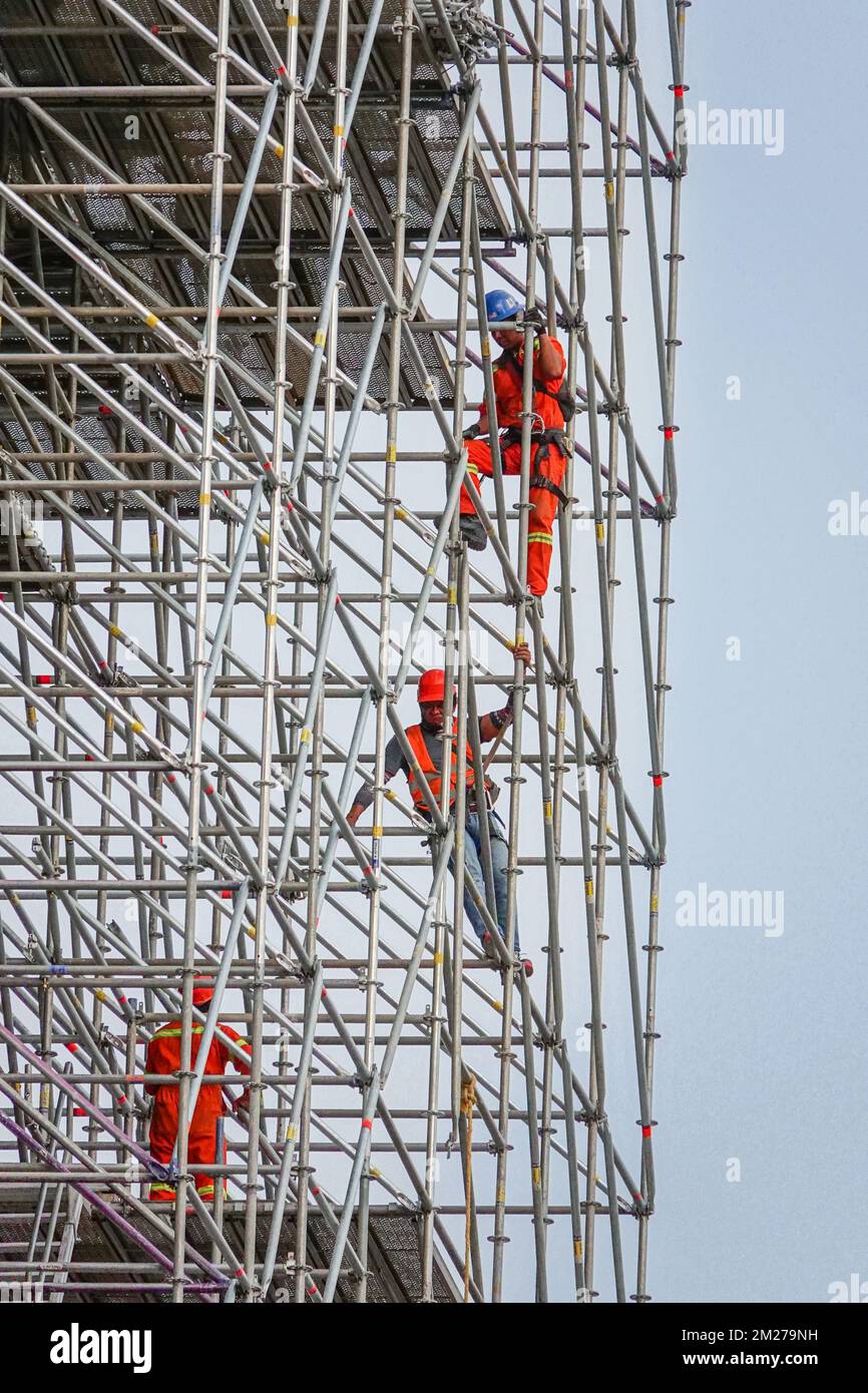 Construction workers assembly scaffolding around the Mexico City Metropolitan Cathedral in Mexico City, Mexico. The home cathedral of the Roman Catholic Archdiocese of Mexico is built on the secret temple of the Aztec empire and took nearly 250-years to complete mixing Gothic, Baroque, Churrigueresque, and Neoclassical styles. Stock Photo