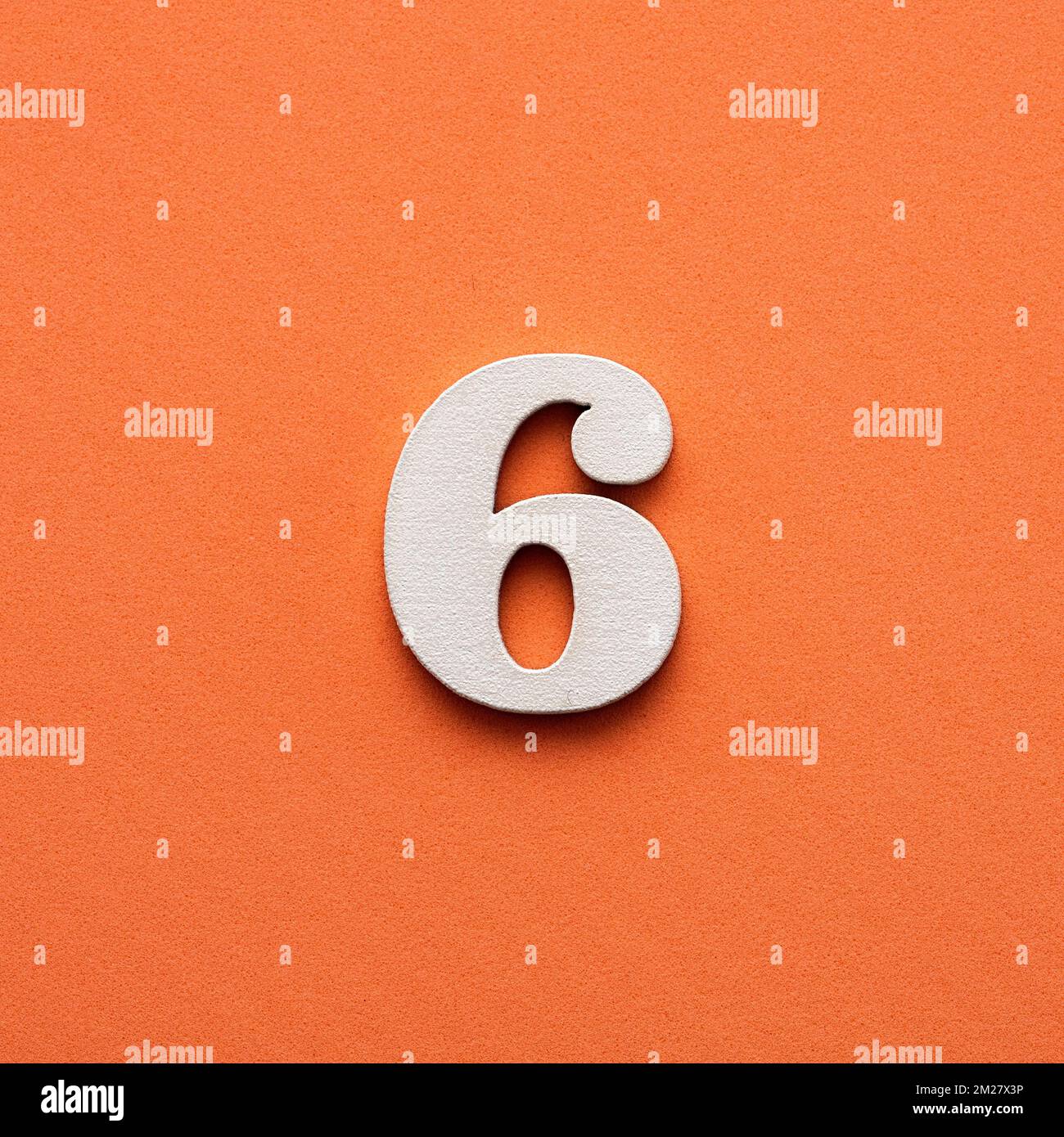 Number six - white number in wood on pink background Stock Photo - Alamy