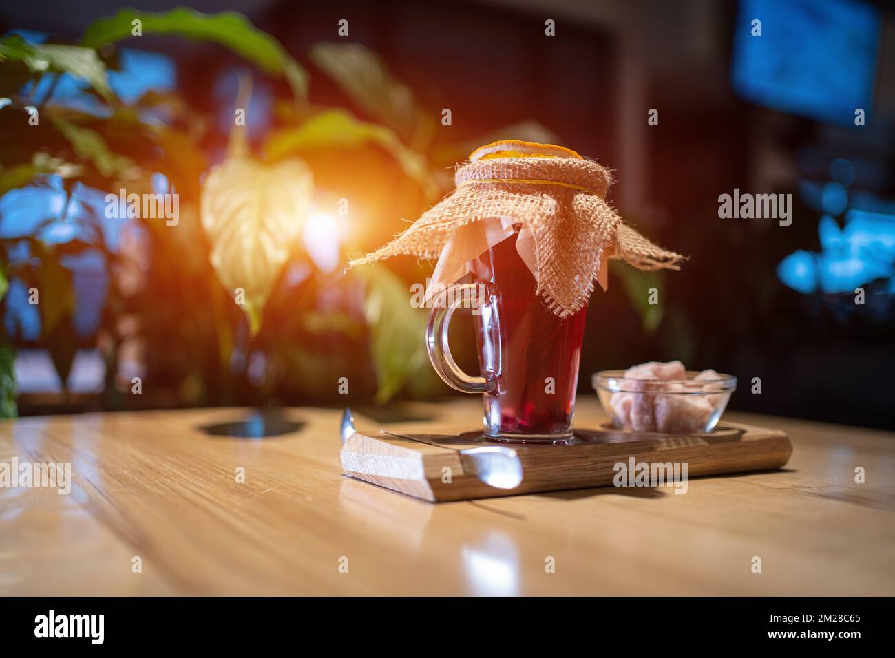 vitamin red pomegranate or berry tea cup with basil, pink sugar on wooden table Stock Photo