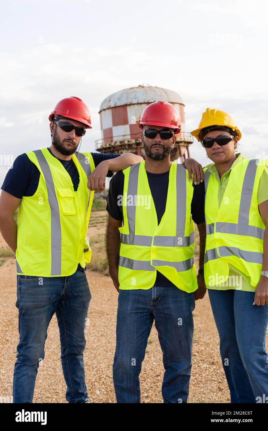 Portrait of three industrial workers standing on a construction site Stock Photo