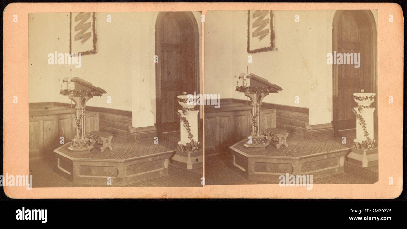 Church pulpit and baptismal font decorated with garlands of greens
