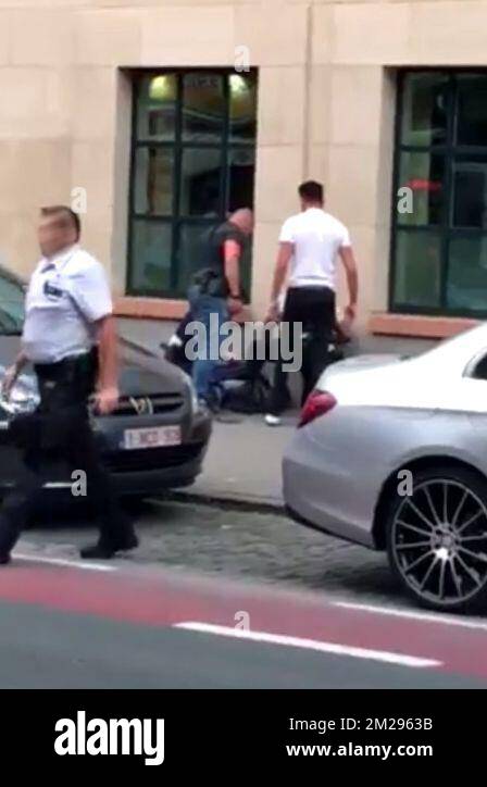 ATTENTION EDITORS: BEST QUALITY AVAILABLE This screengrab police and soldiers check up on the perpetrator on the scene where a man attacked soldiers with a knife and was shot in the Boulevard Emile Jacqmain - Emile Jacqmainlaan in the city centre of Brussels, Friday 25 August 2017. BELGA PHOTO SCREENGRAB  Stock Photo