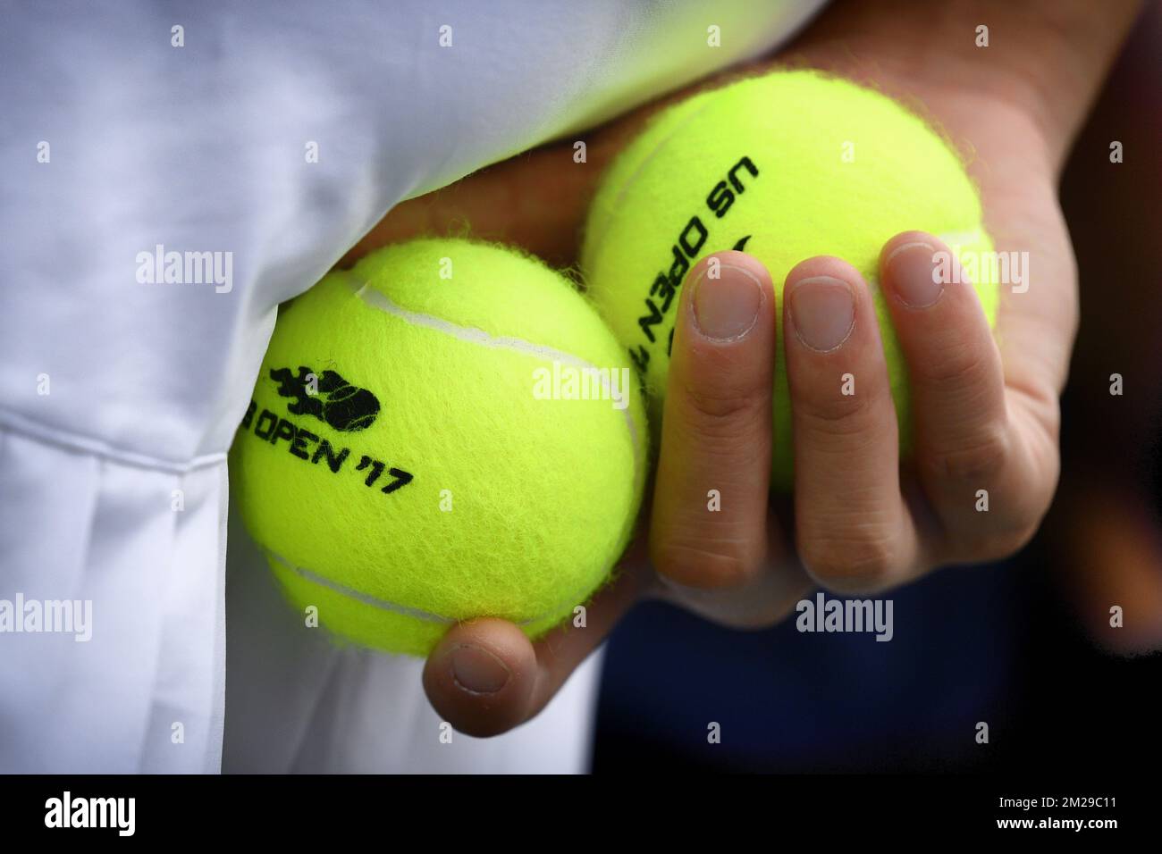 Illustration picture shows the hand of a ball girl holding the official US  Open Wilson match balls before the start of a tennis match between Belgian  David Goffin and French Gael Monfils,