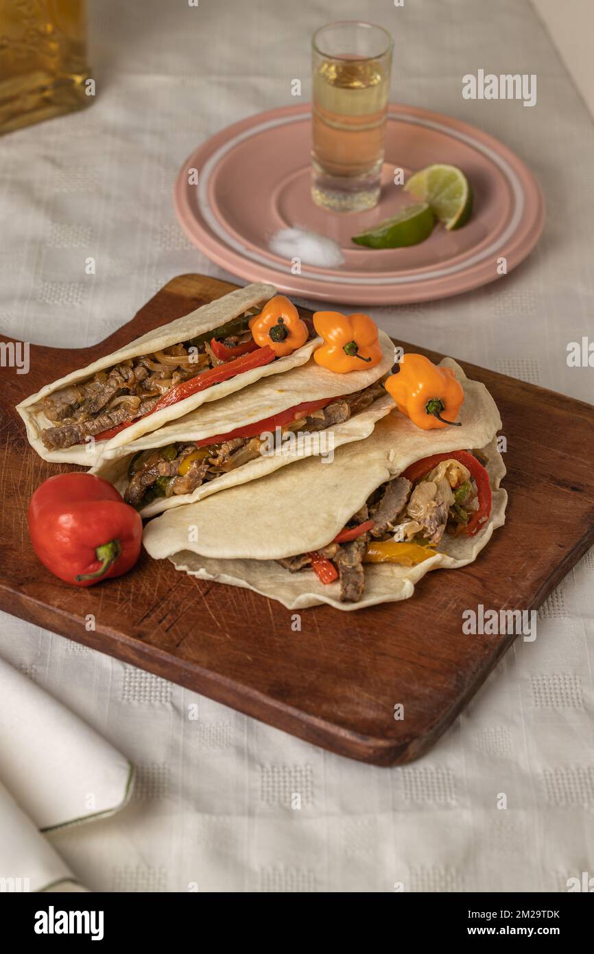 Tacos, typical Mexican food, with beef, vegetables and spices on a
