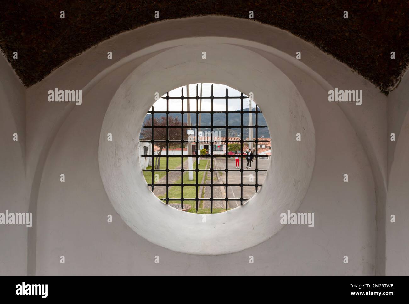 Historical Rounded Windows An old colonial rounded window with metal grid into a structure with ...