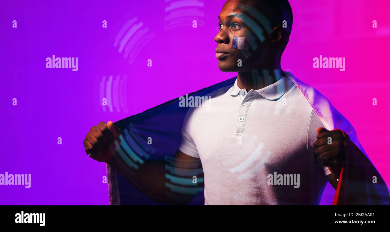 Thoughtful african american rugby player with french flag standing over illuminated circle Stock Photo