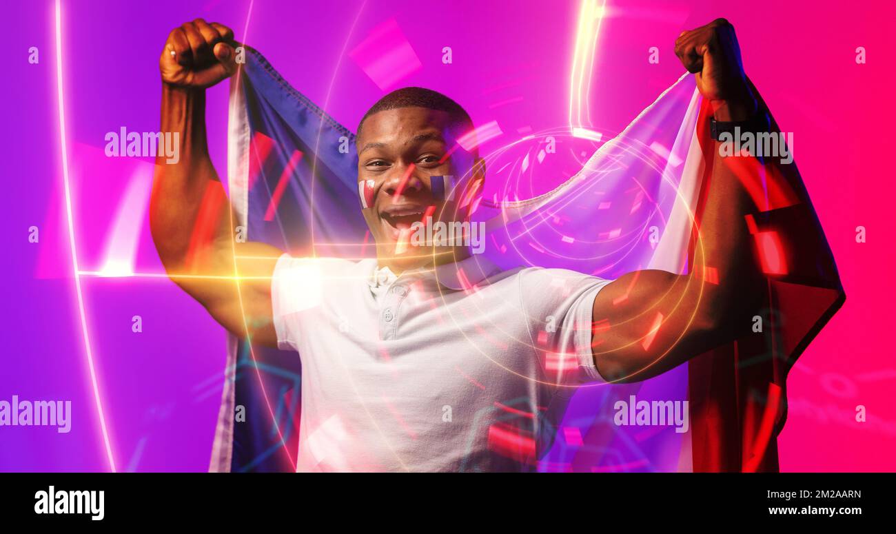 Cheerful african american rugby player with french flag screaming over illuminated circle Stock Photo