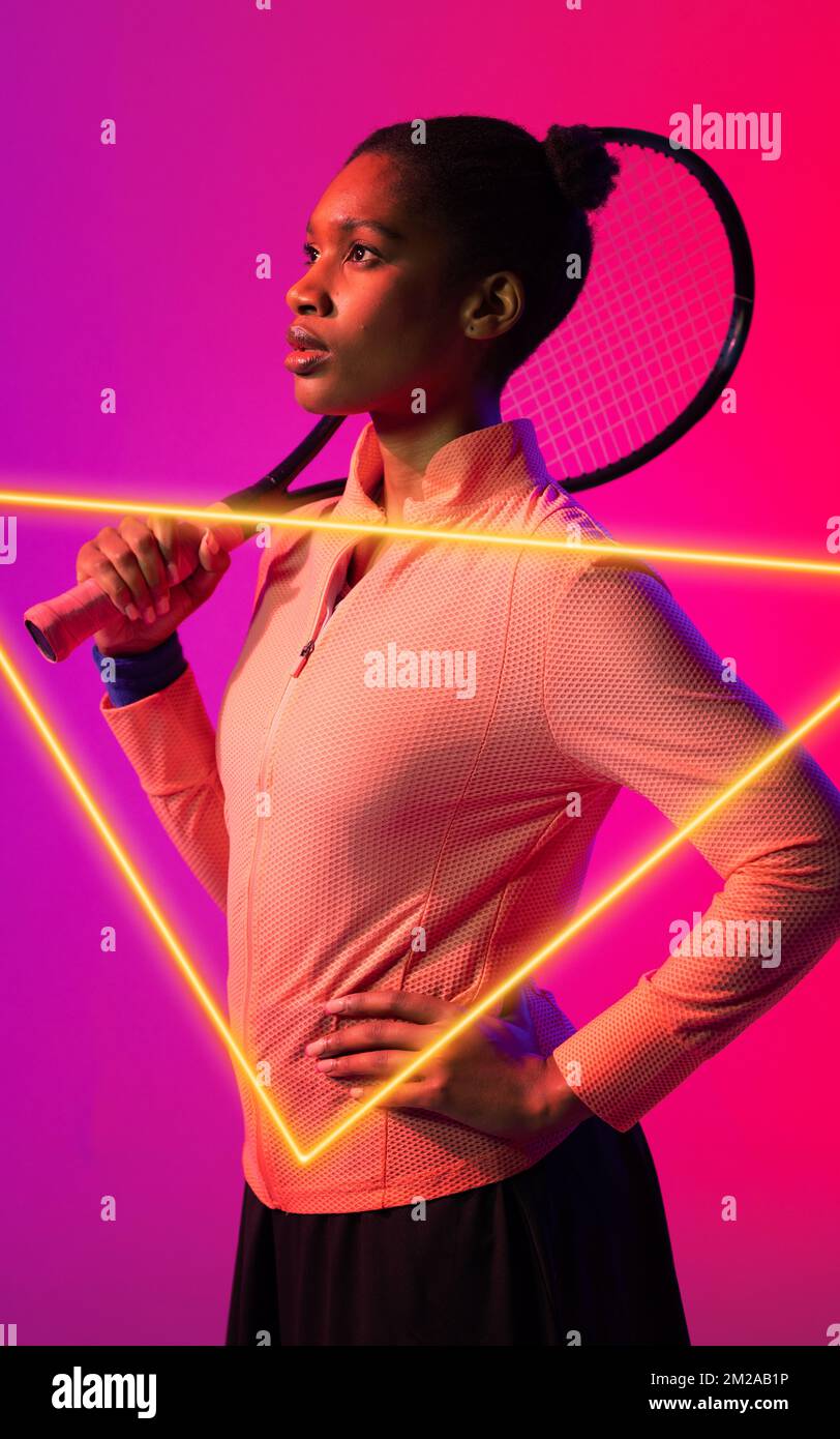 African american female tennis player with hand on hip holding racket ...