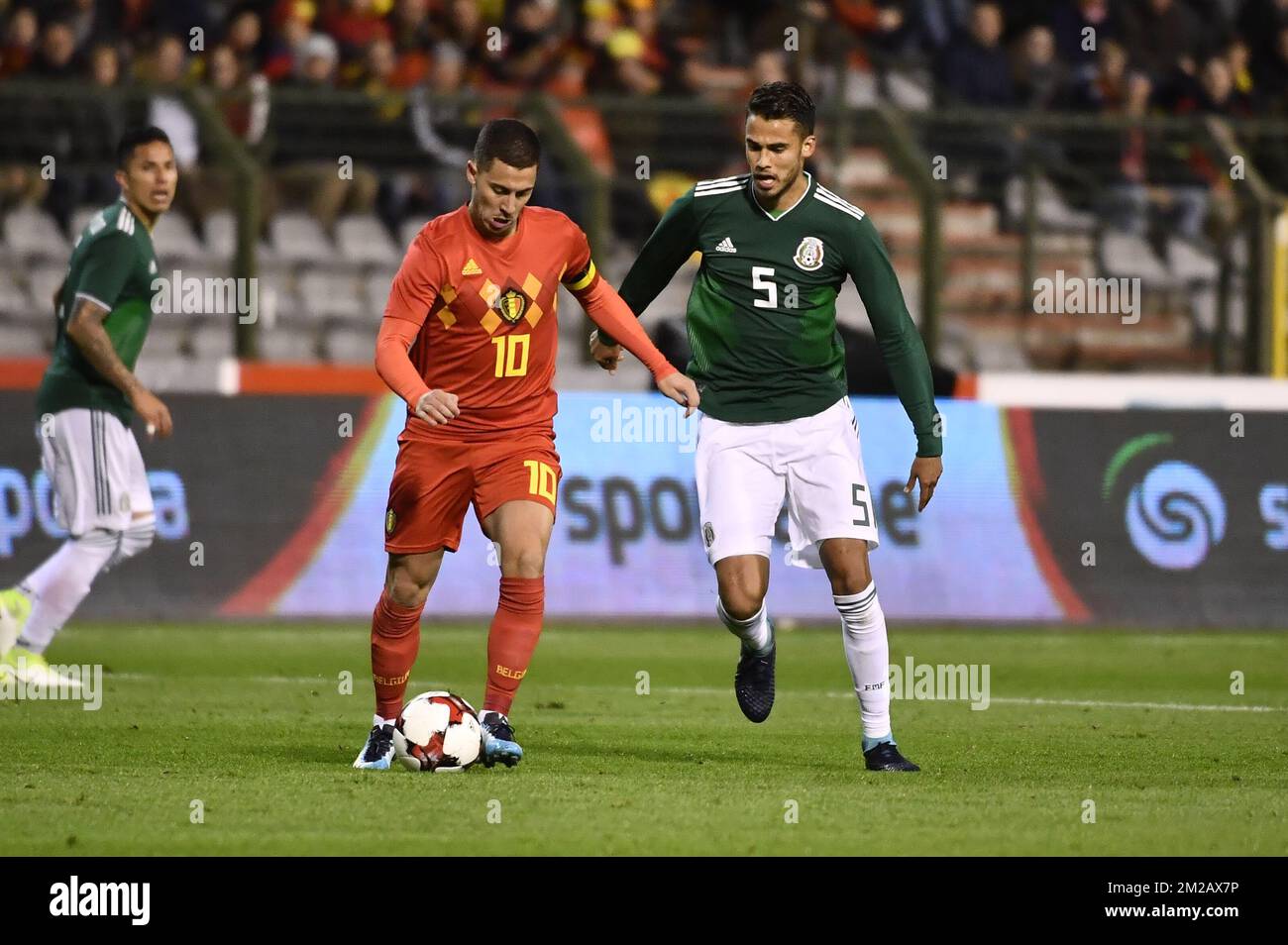 Belgium's Eden Hazard and Mexico's Diego Reyes fight for the ball during a friendly soccer game between Belgian national team Red Devils and Mexico, Friday 10 November 2017, in Brugge. BELGA PHOTO DIRK WAEM Stock Photo