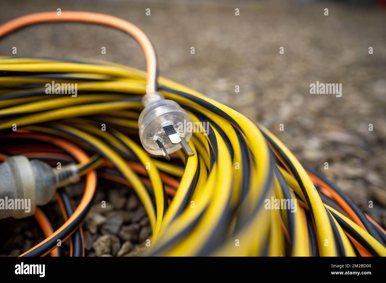 extension cord wrapped up on the ground. extension lead, power lead on a construction site Stock