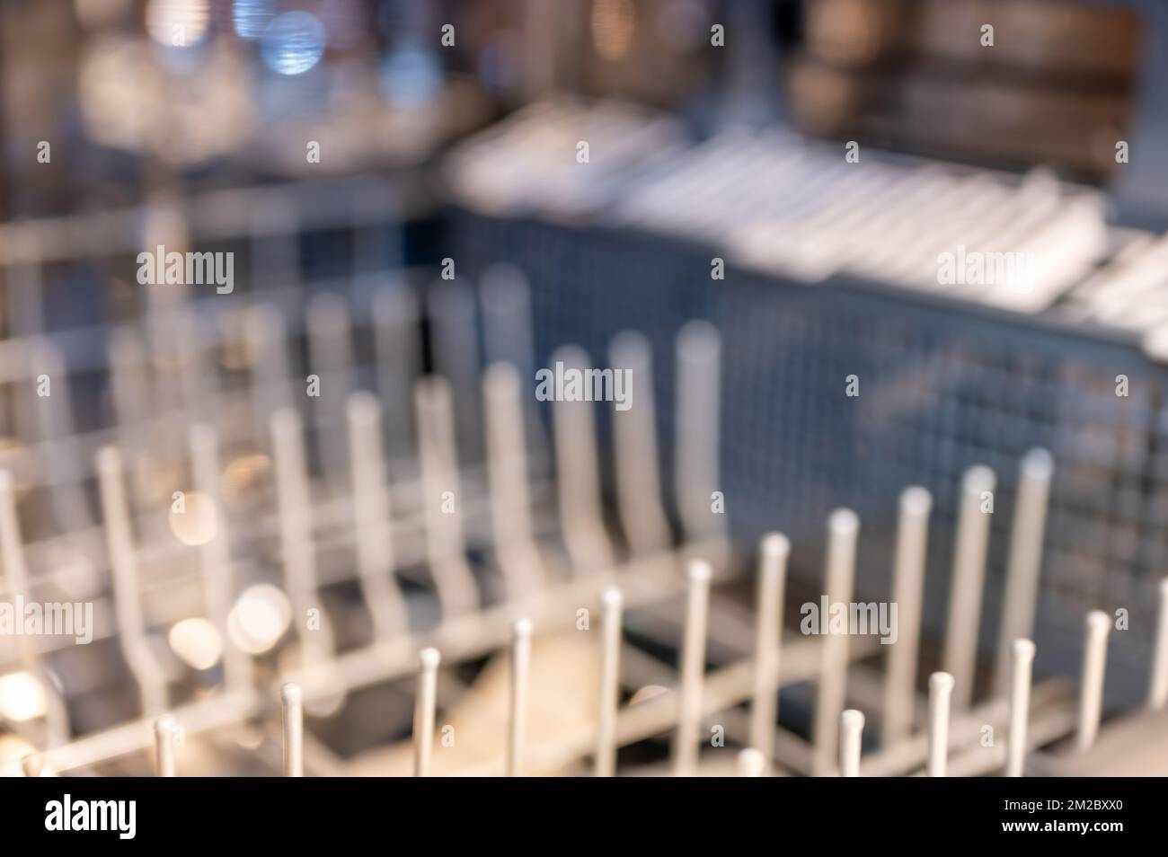 Selective focus on upper dishwasher plastic coated wire rack Stock