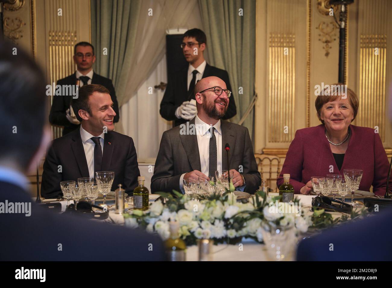 Belgian Prime Minister Charles Michel (C) talks, with President of France Emmanuel Macron (C-L) and Chancellor of Germany Angela Merkel (C-R) and others listening, during an informal dinner for European Heads of State, hosted by the Belgian Prime Minister at the 'Val Duchesse - Hertoginnedal' Castle in Auderghem - Oudergem, Brussels Thursday 22 February 2018. BELGA PHOTO CHANCELLERIE OF THE PRIME MINISTER  Stock Photo