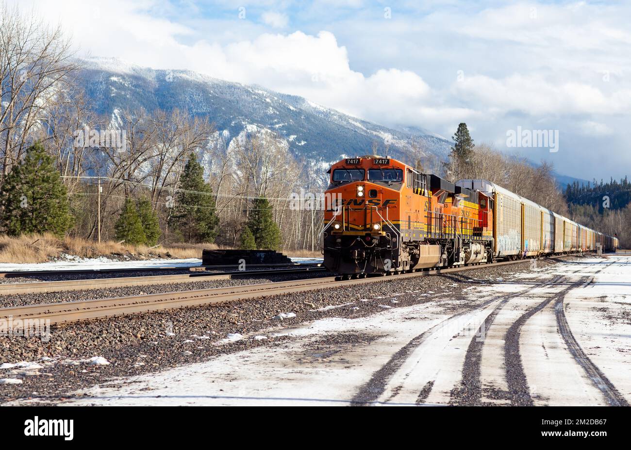 A BNSF diesel electric train locomotive coming through the rail yard in the town of Troy, Montana. Stock Photo