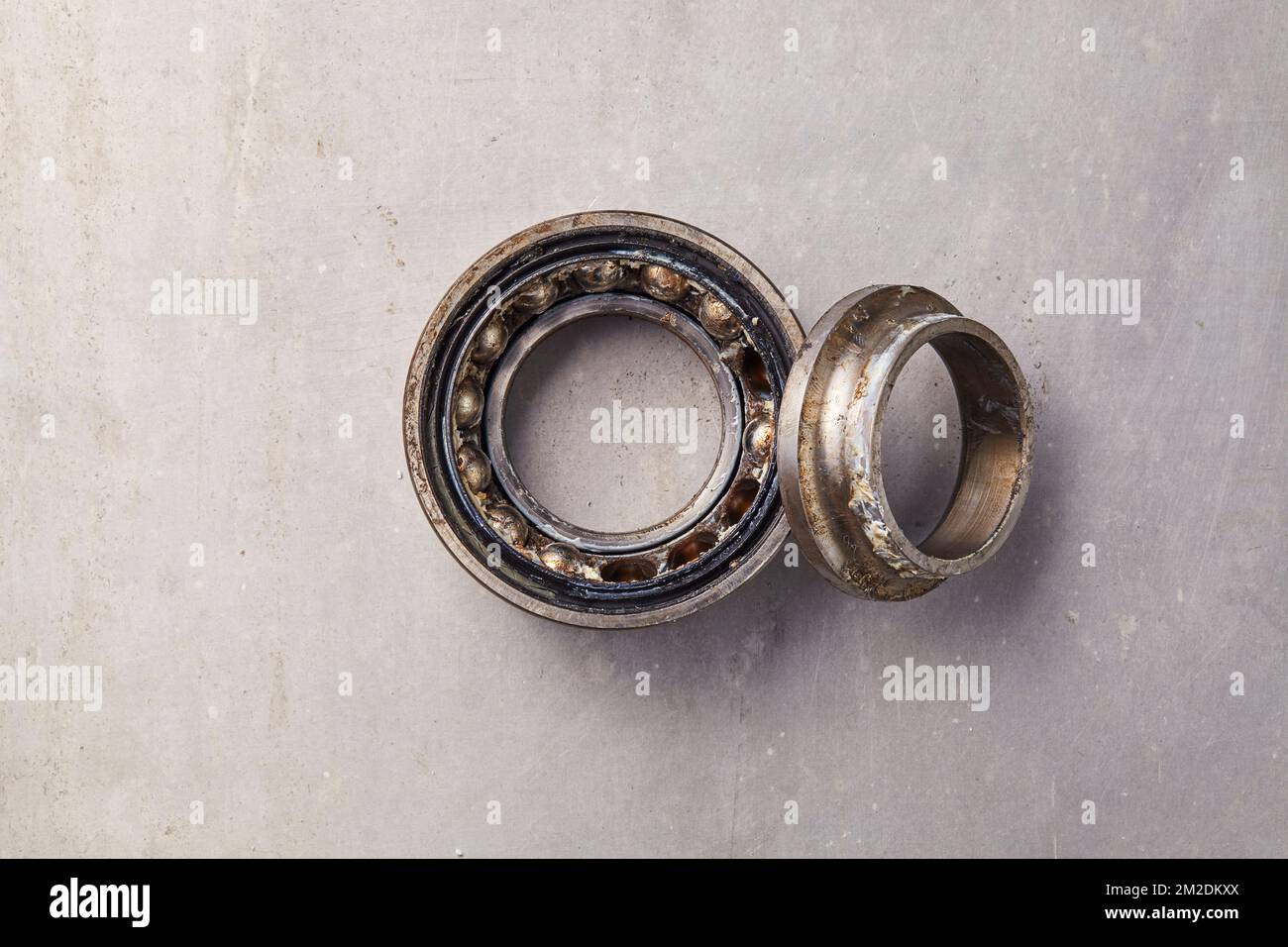 A used broken wheel bearing that must be replaced in a car maintenance