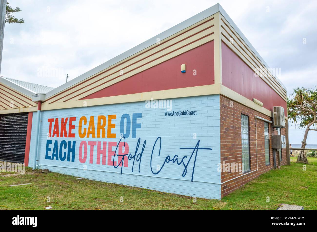 The John Cunningham Lifeguard Centre at Coolangatta, gold coast, queensland, australia with sign 'take care of each other' on the wall facing the road Stock Photo
